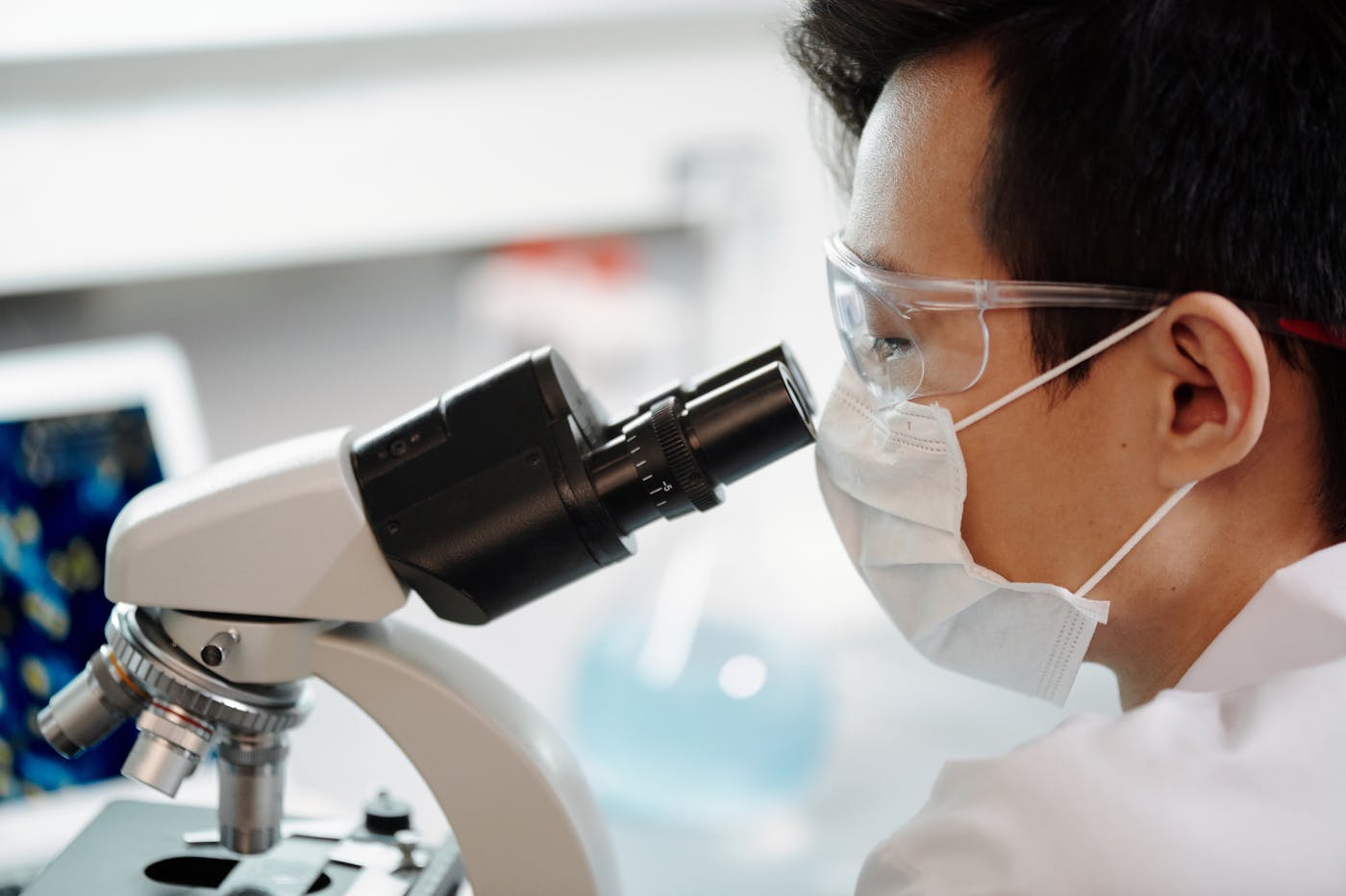 Scientist looking through a microscope